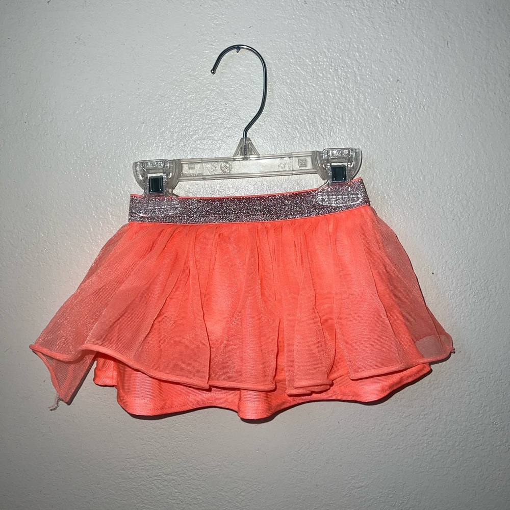 2 Tutus. 1 Coral and 1 white black pants.